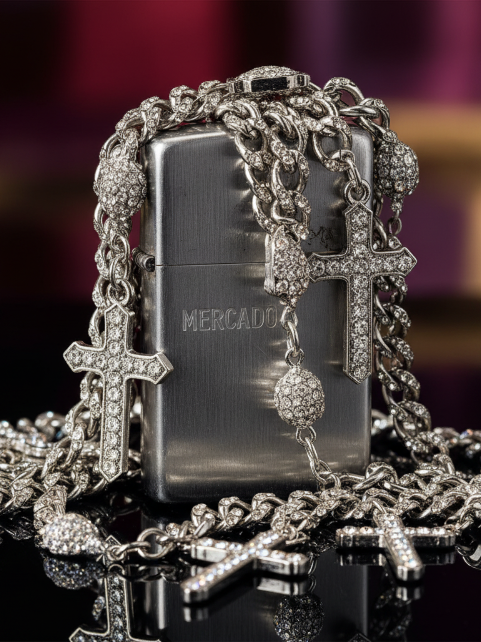 Silver Zippo lighter with decorative chain and cross pendants on a reflective surface.
